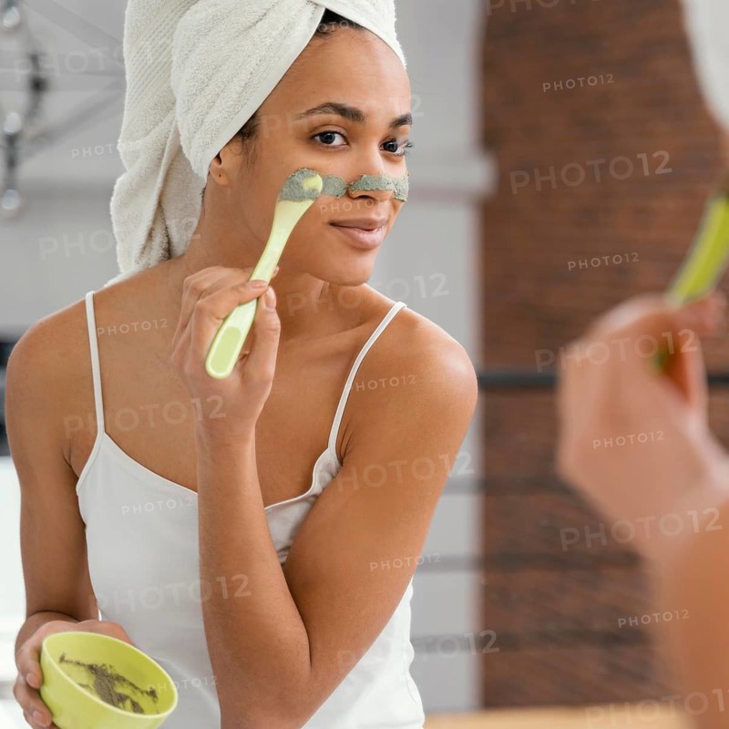 Woman applying homemade mask her face