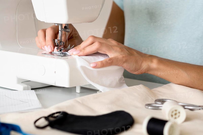 Woman using sewing machine face mask