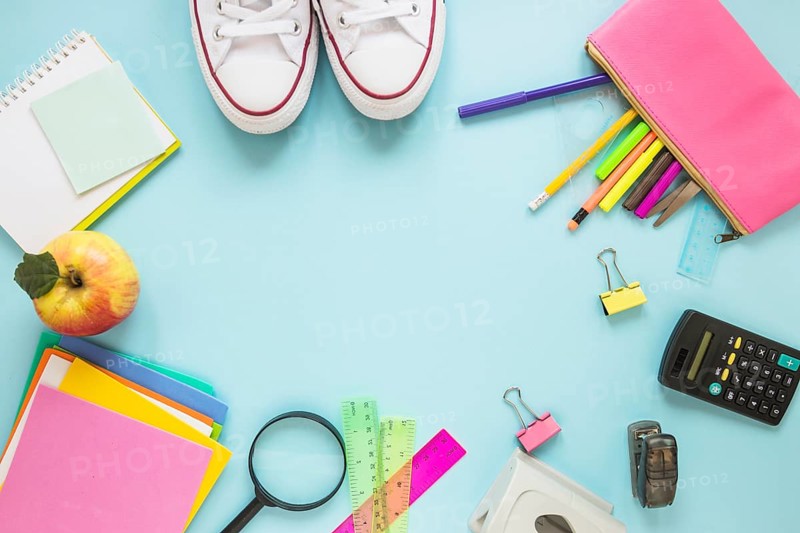 Writing implements sneakers laid circle