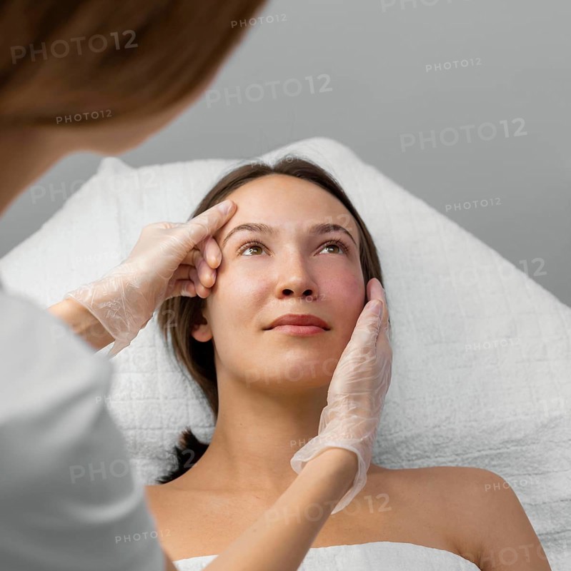Beautician with female client salon face care routine 9