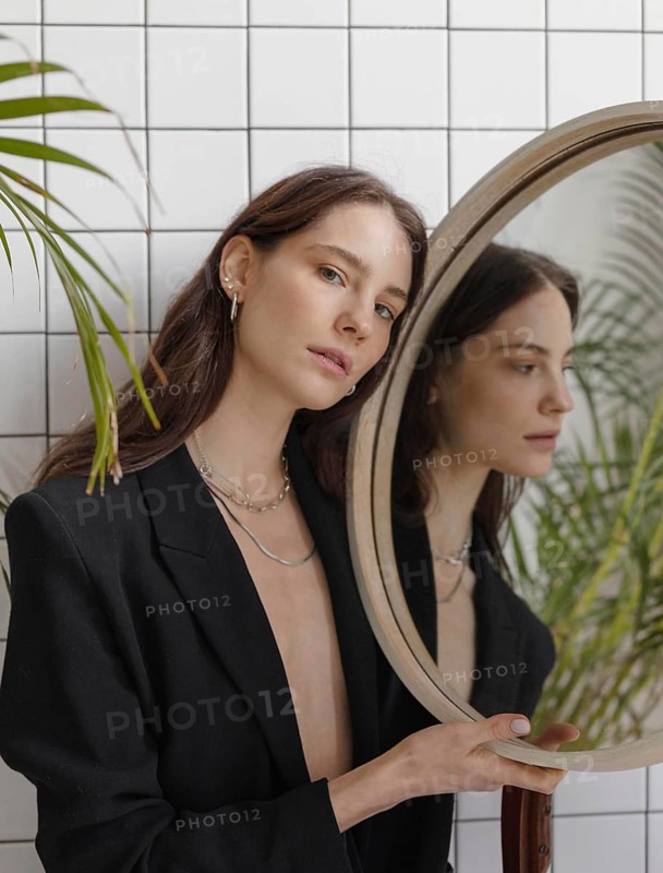 Beautiful young female posing mirror