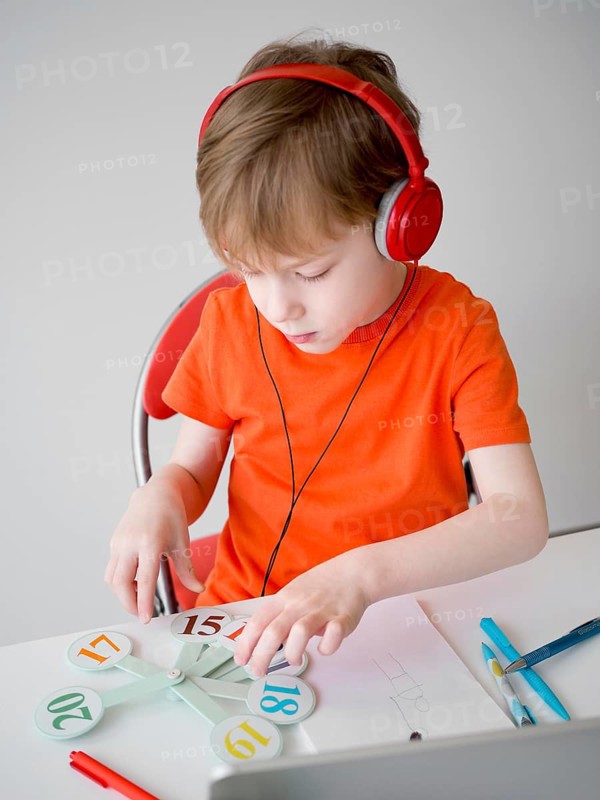 Child wearing headphones e learning concept