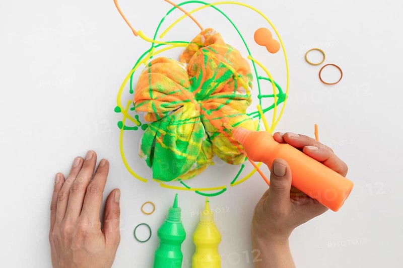 Close up hand holding paint tube