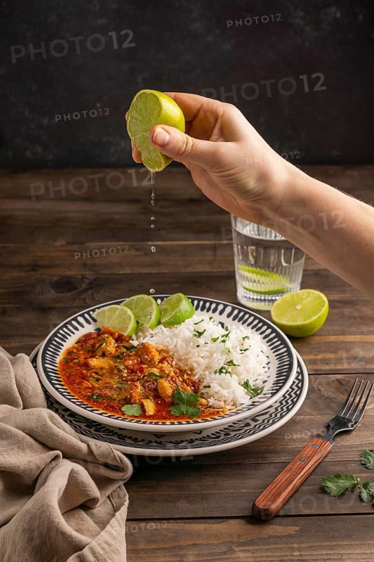 Close up hand squeezing lime juice