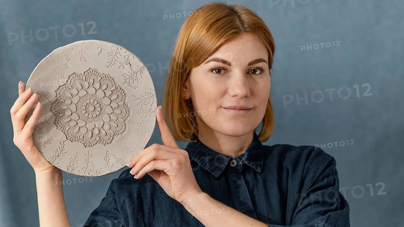 Close up smiley woman holding plate