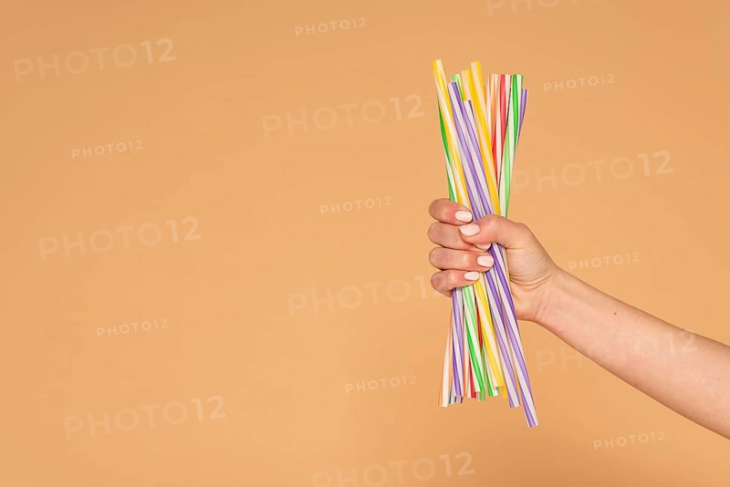 Close up woman hand with plastic straws
