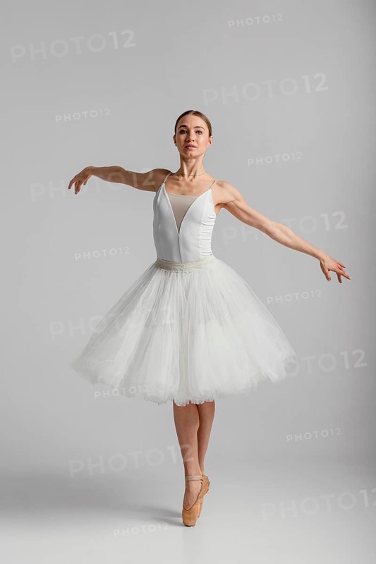 Full shot ballerina standing pointe shoes