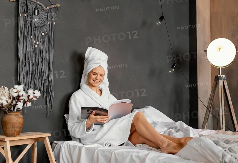Full shot woman reading magazine