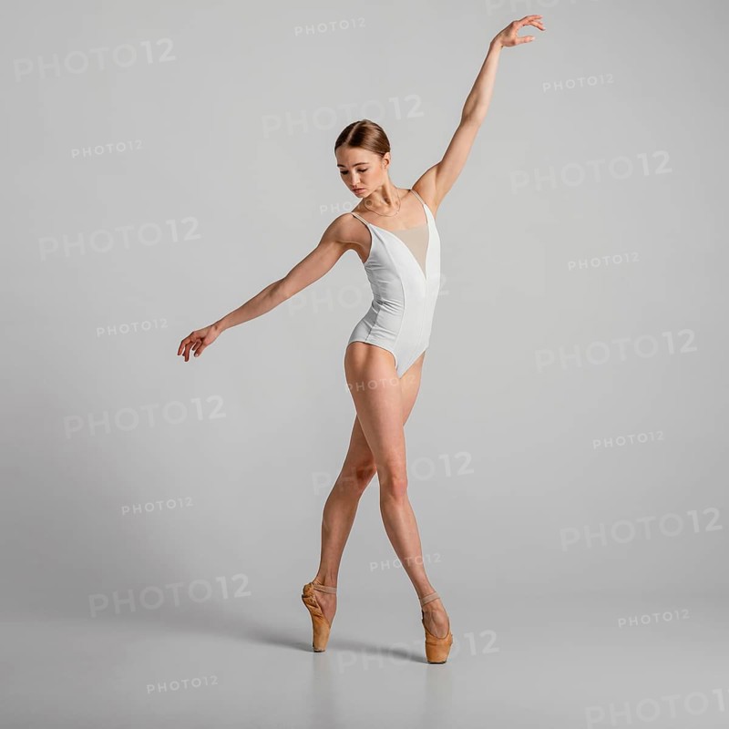 Full shot woman standing pointe shoes