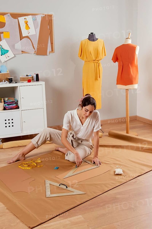 Full shot woman working with fabric