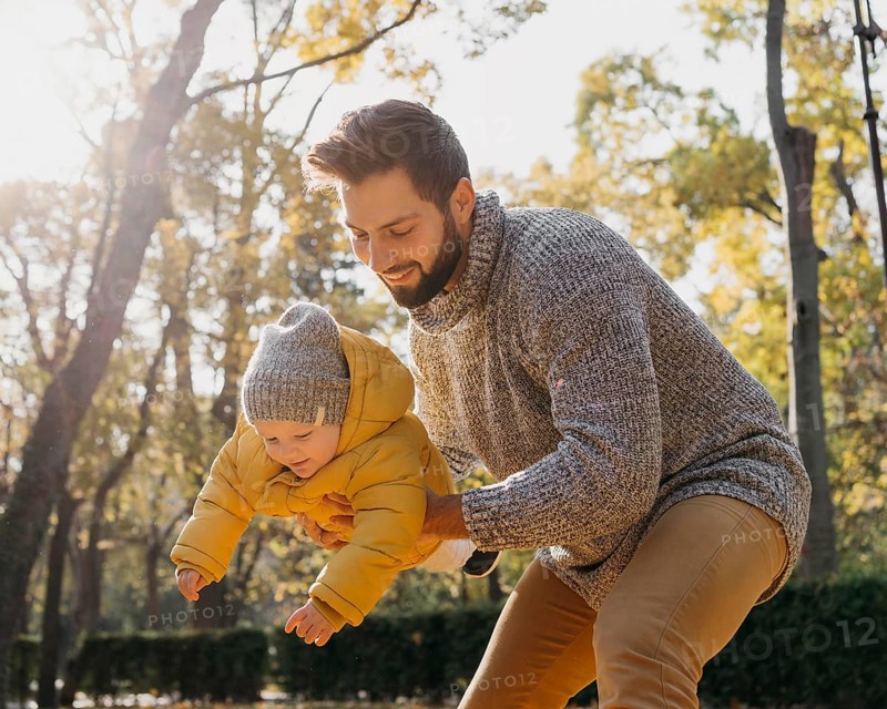 Happy father with baby outdoors