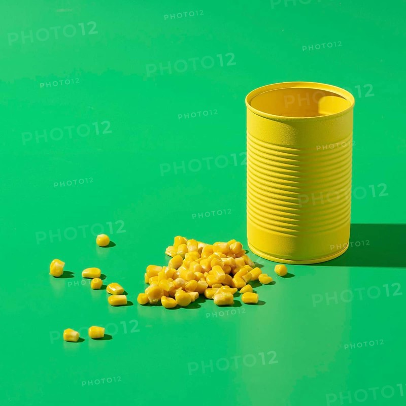 High angle yellow tall round tin can with corn