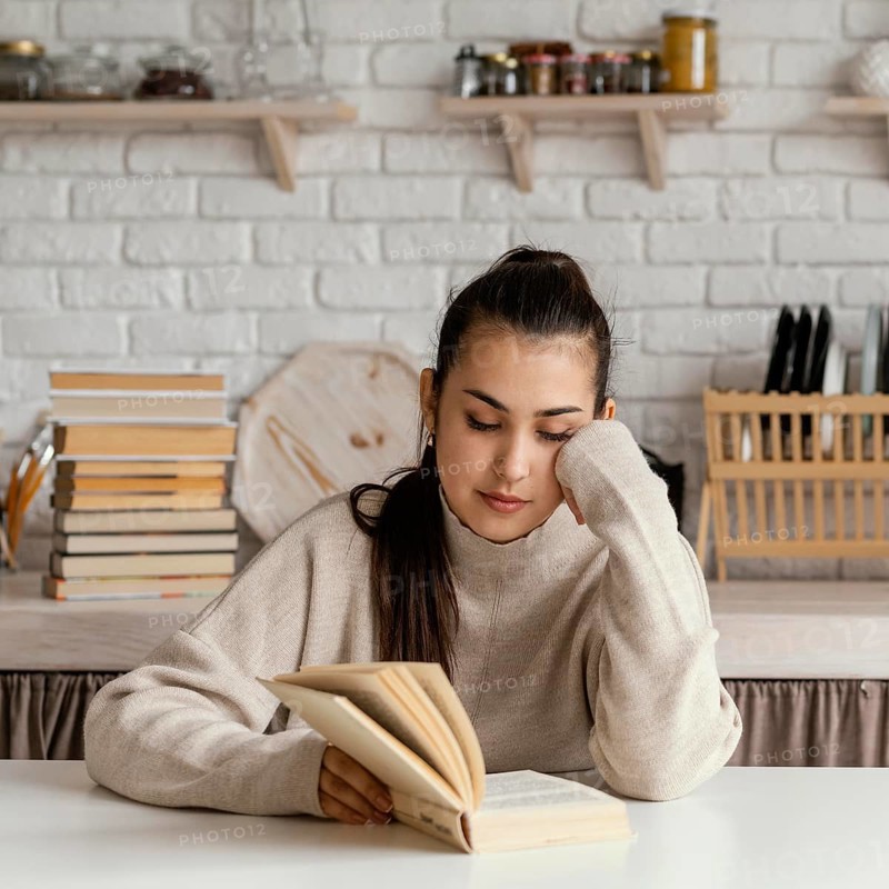 Medium shot woman reading table