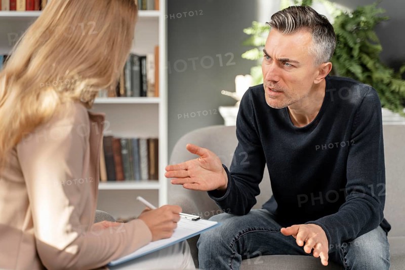 Mid shot man talking woman therapist