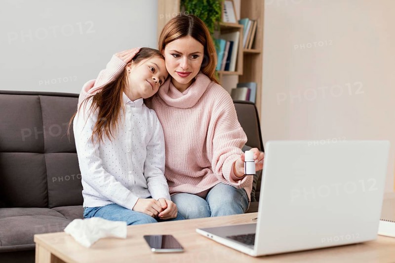 Patients consulting doctor with laptop