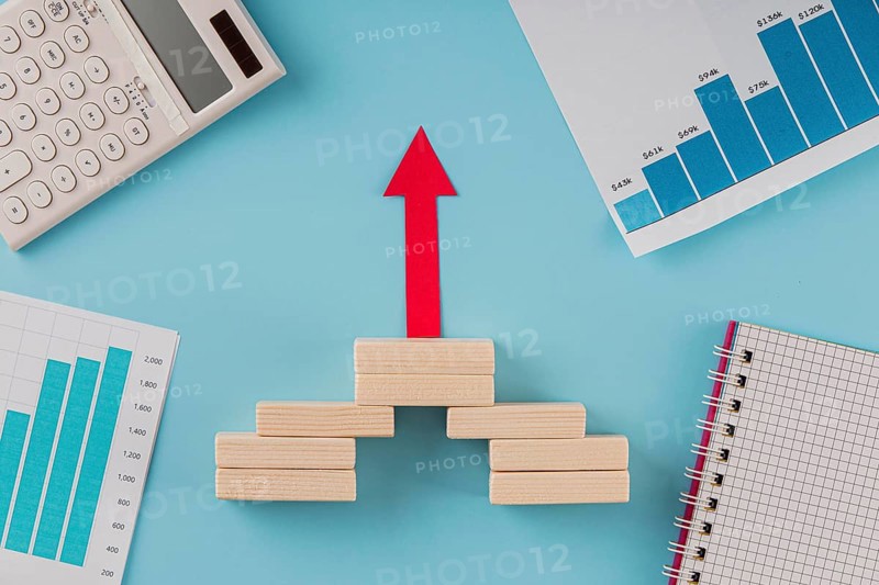 Top view business items with growth chart arrow