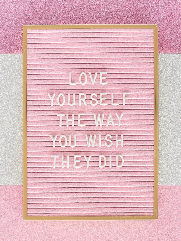 Pink motivational text board top view