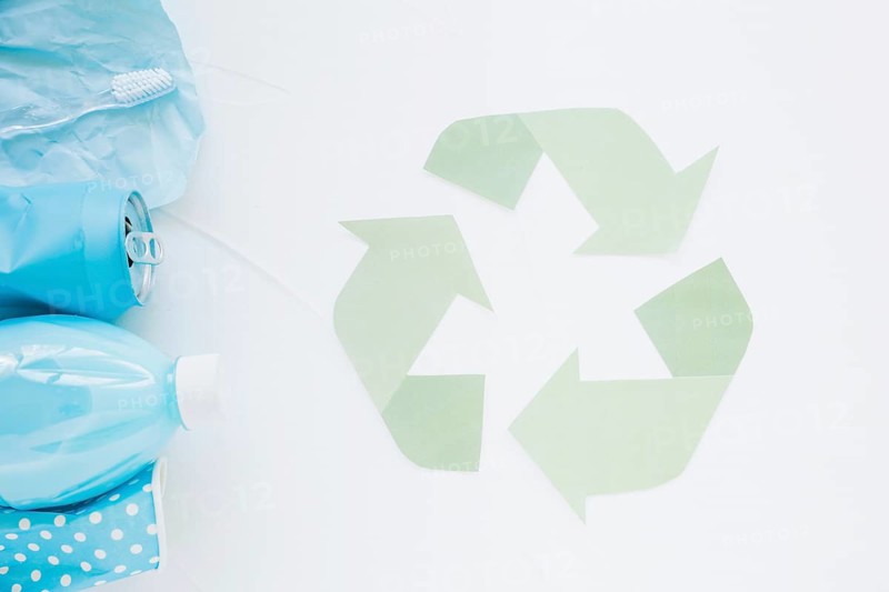 Recycle logo with colorful garbage
