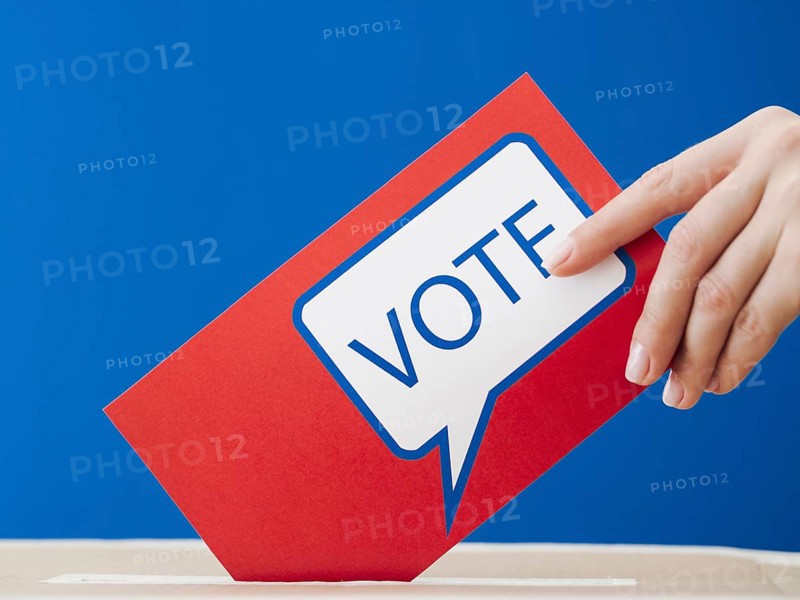 Woman placing her ballot election box