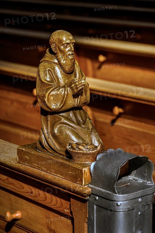 Praying figure on a church bench