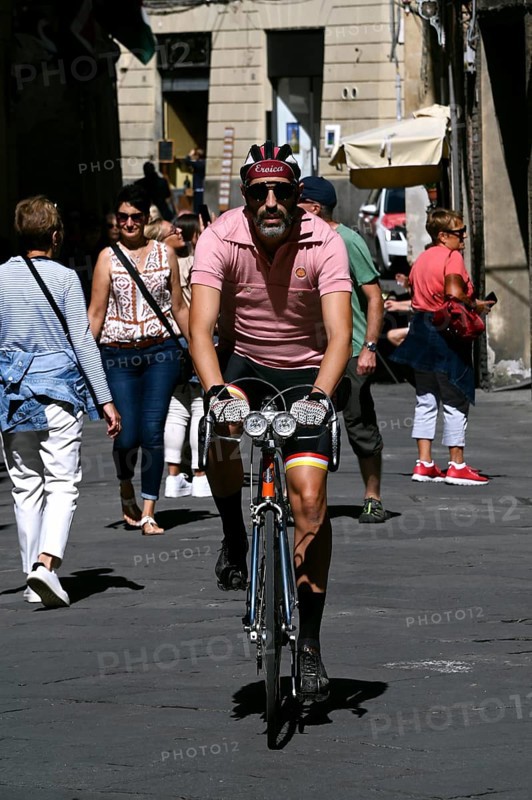 Racing cyclist with historical outfit of the Eroica in Siena