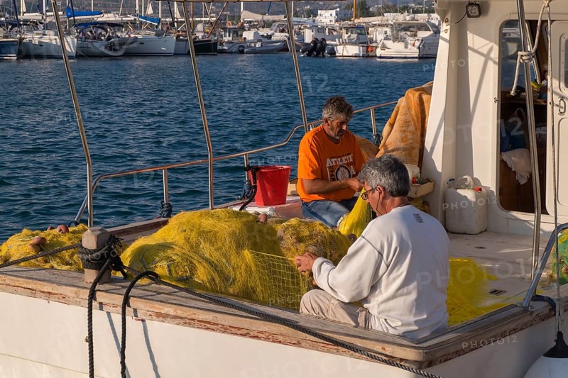 Fishermen mending nets