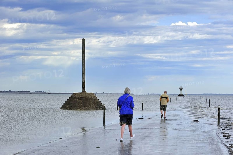 Tourists waiting for low tide to uncover the Passage du Gois
