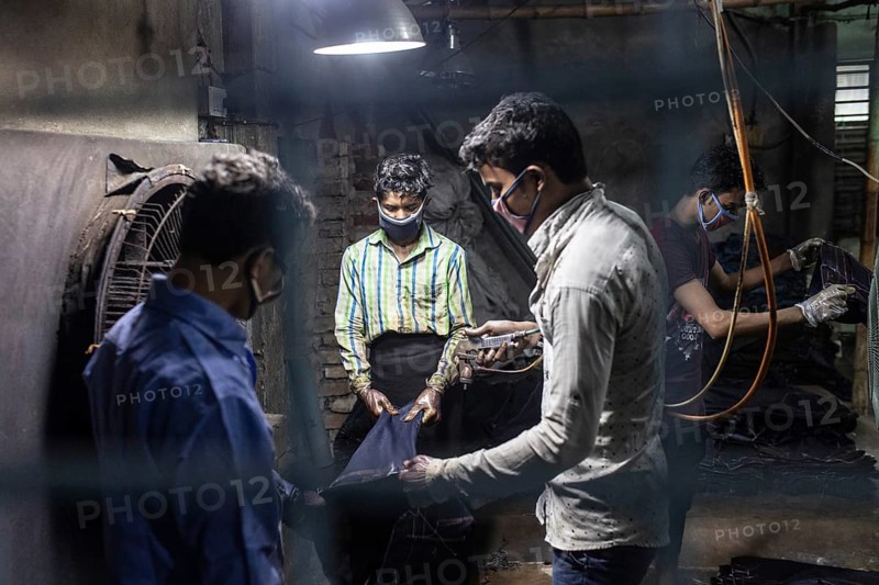 Workers colouring jeans in a textile factory