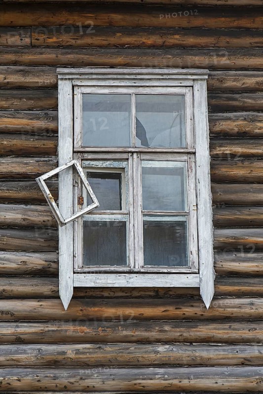 Window of derelict wooden building at Pyramiden
