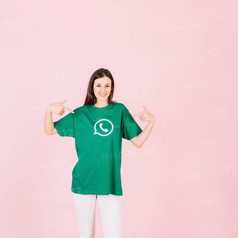 Portrait smiling woman pointing her t shirt with whatsapp icon