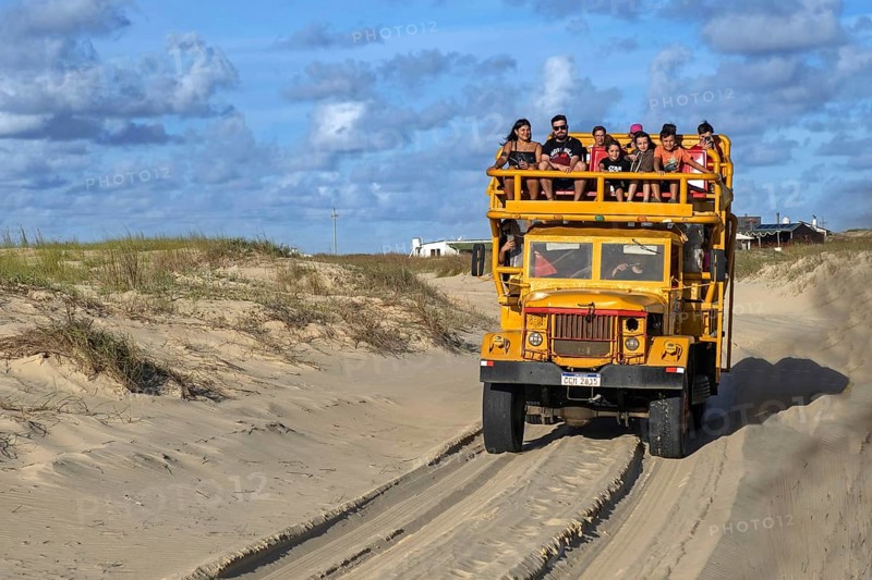 Yellow 4x4 truck transporting tourists to the sand dunes and beach of Cabo Polonio National Park
