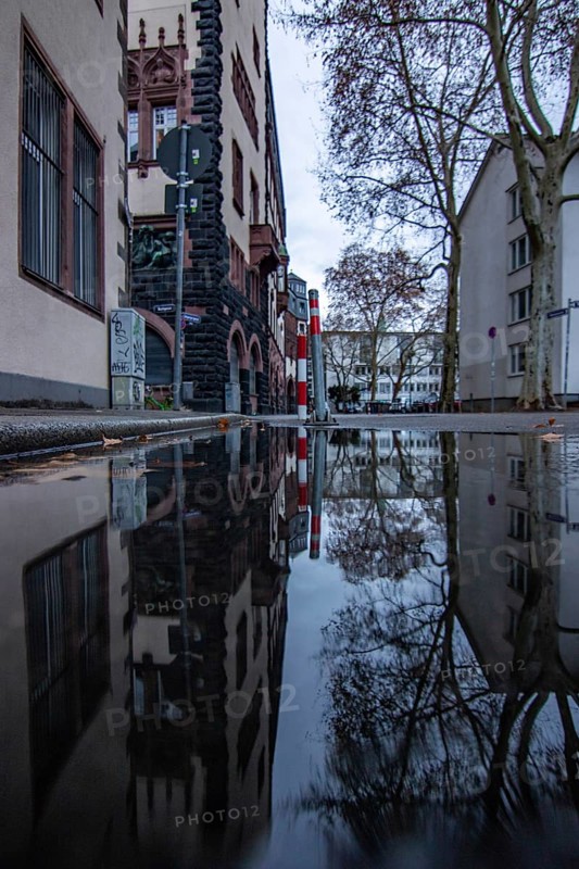 Reflection in a puddle between a historic city centre. Cityscape at the Roemer and the historic houses and streets. Cityscape in Frankfurt am Main