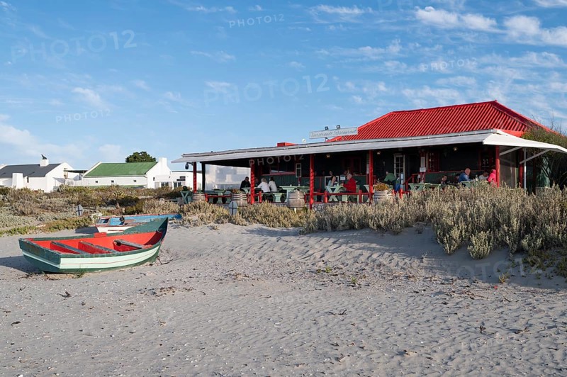 Fishing boat in front of beach restaurant