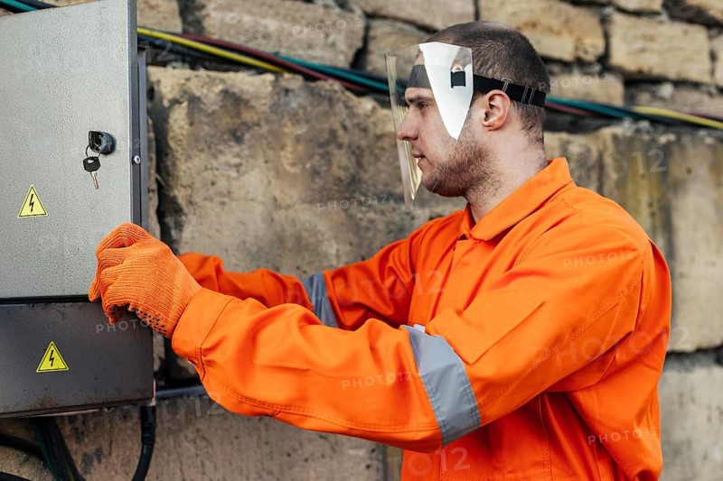 Side view electrician uniform with protective gloves face shield