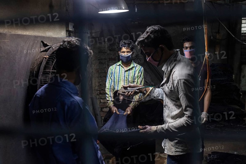 Workers colouring jeans in a textile factory