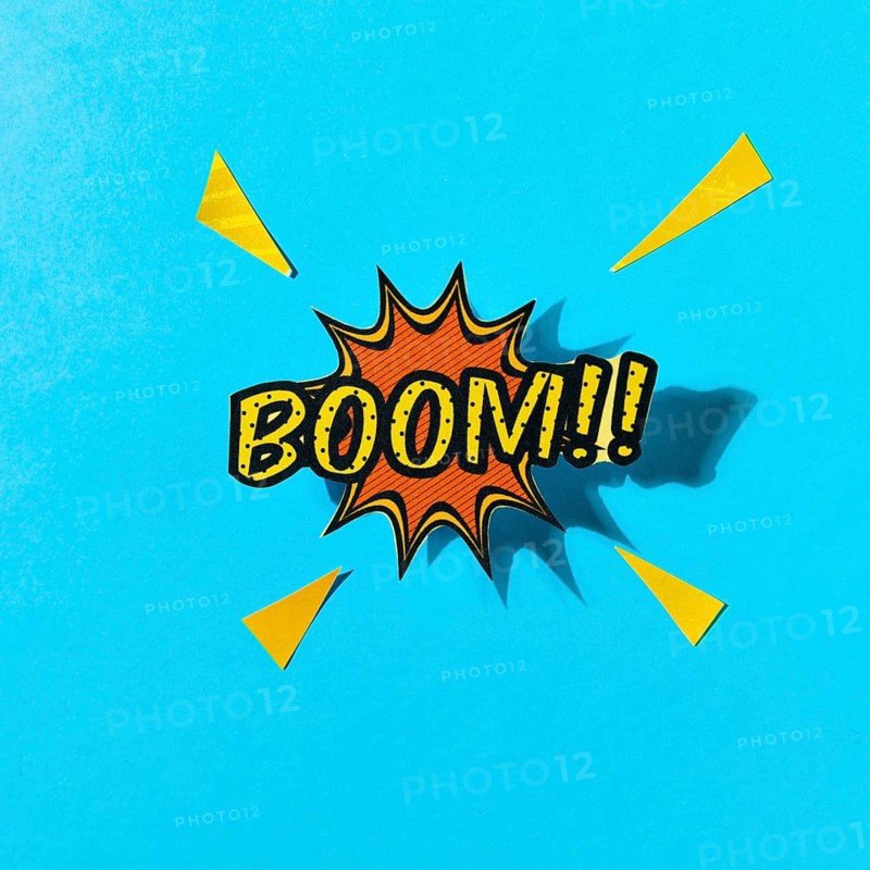 Pop art comics boom speech bubble against blue backdrop