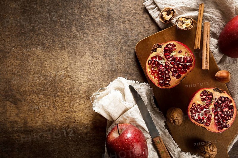 Top view autumn pomegranates with copy space cinnamon sticks