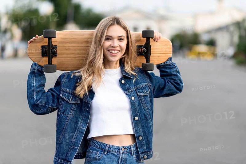 Medium shot woman holding skateboard