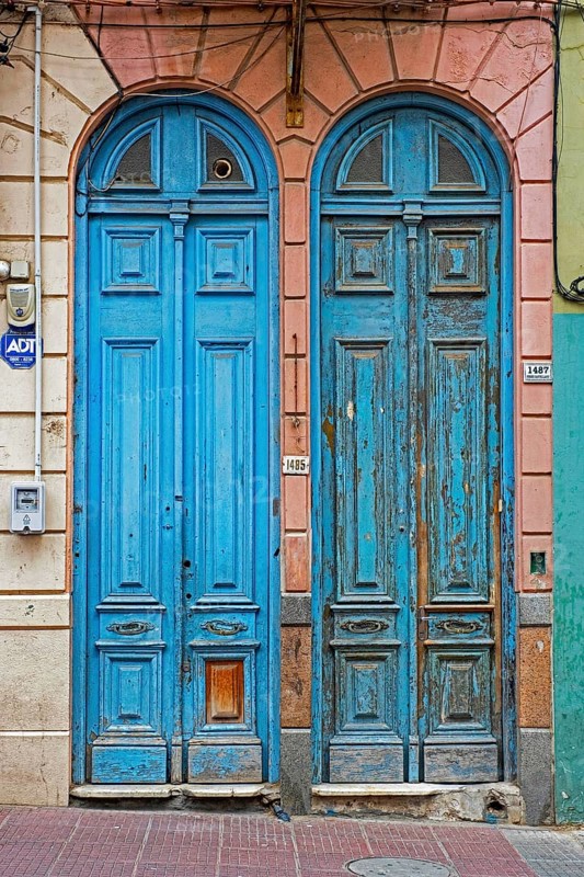 Two blue narrow front doors of colonial houses in the Ciudad Vieja