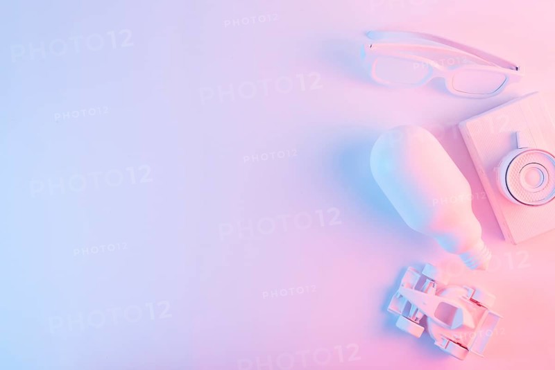 Overhead view lightbulb spectacles formula one car camera against pink backdrop with blue light