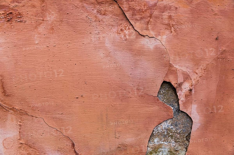 Paint peeling off concrete wall surface