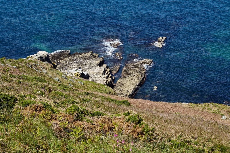 Cliff with rocks in the Atlantic Ocean near Cap Frehel in Plevenon