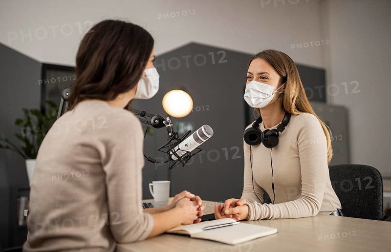 Smiley women doing radio with medical masks