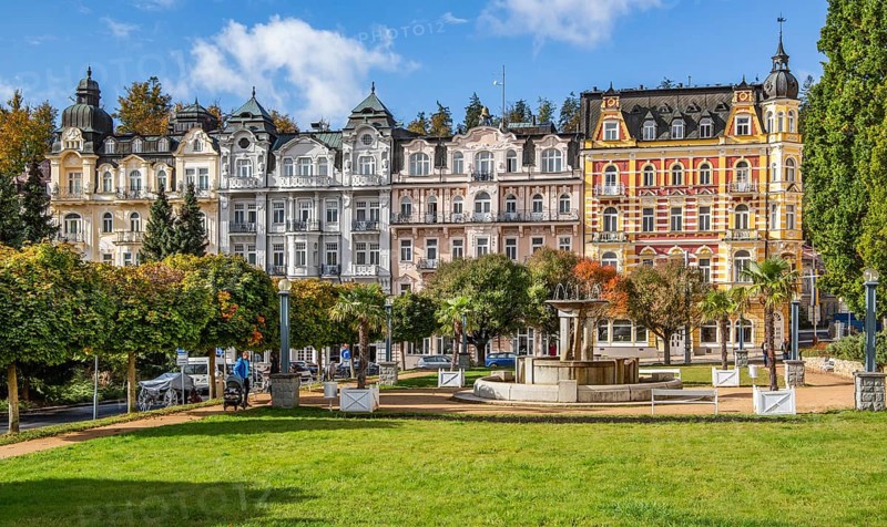 Row of houses with Art Nouveau facades by the autumnal spa park