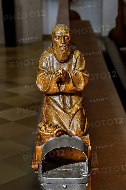 Praying figure on a church bench