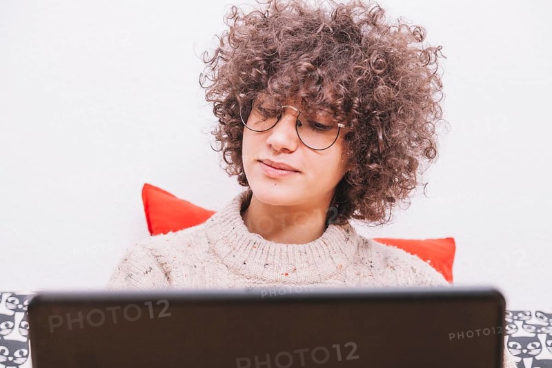 Teenager glasses using laptop