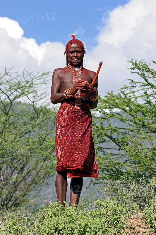 Portrait of young Turkana warrior in traditional red clothing in northwest Kenya