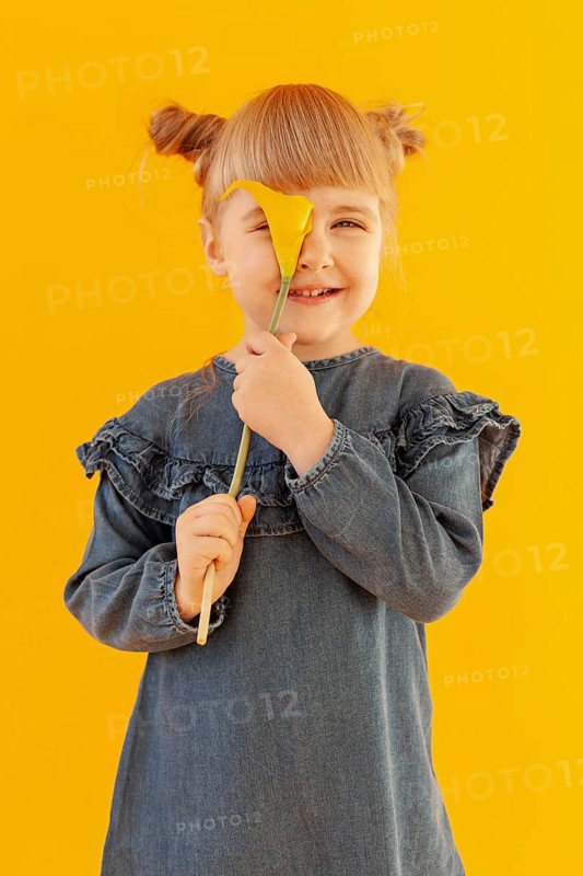 Happy girl holding calla lily flower