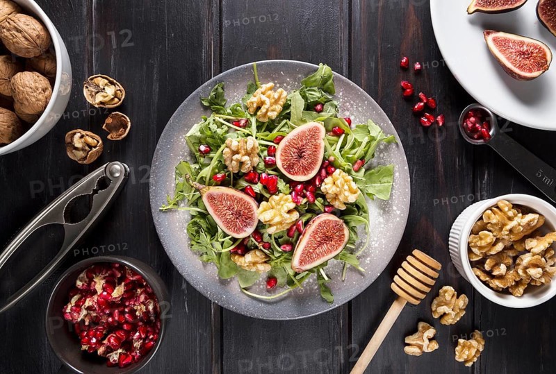 Top view plate with autumn fig salad walnuts
