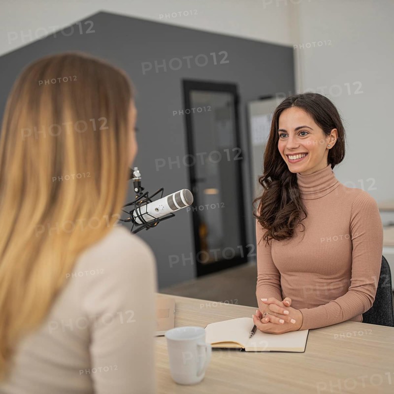 Two women broadcasting together radio